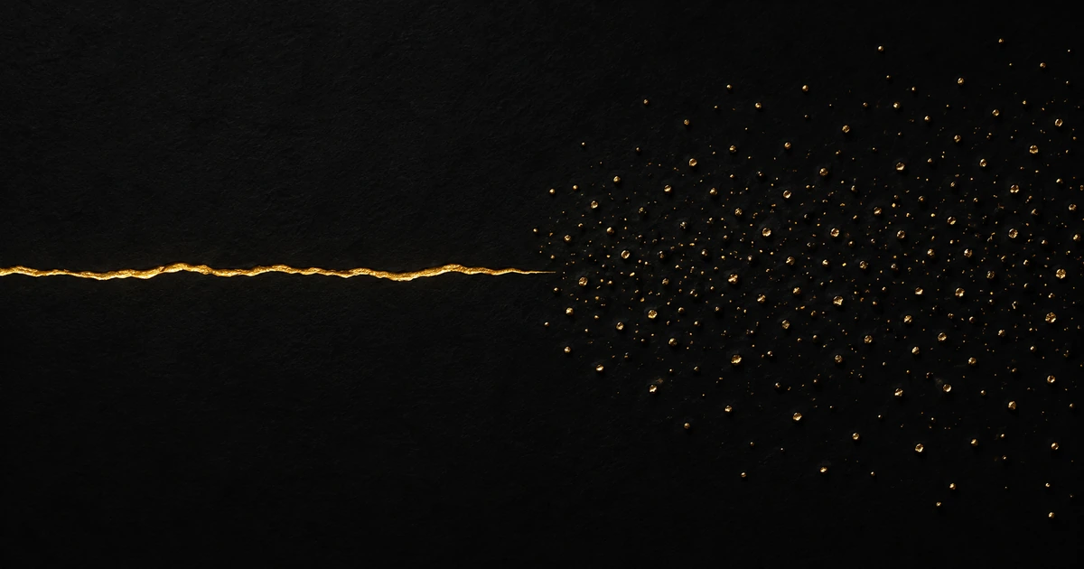 A dark surface crossed by one continuous gold seam on one side and scattered fine gold punctures on the other