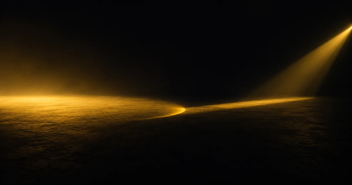 A broad soft pool of gold light and a narrow far-reaching beam, overlapping in one small crescent